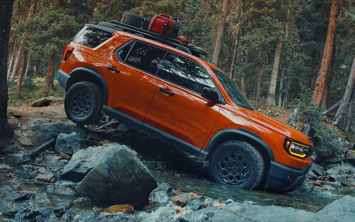 2026 Honda Passport off-road SUV driving through rocky terrain