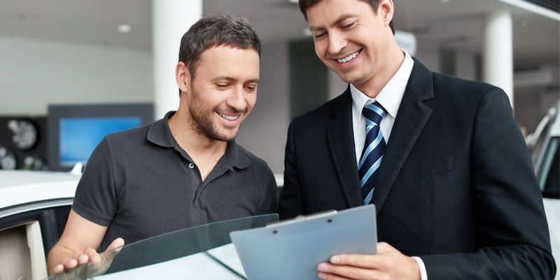 McCarthy Auto Group in Olathe KS sales rep going over paperwork with customer